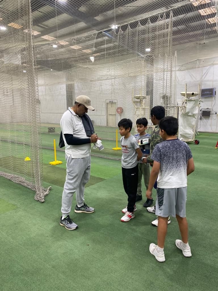 Coach talking through drills with a small group